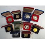 A collection of 10 silver proof crowns in their original boxes some with certificates to include