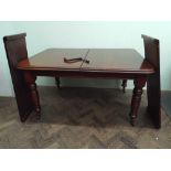 A late Victorian mahogany extending dining table with 2 additional leaves rounded edges and wind