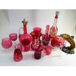 Large collection of Cranberry glass to include a Mary Gregory style enamelled jug together with a