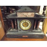 A large black and rouge marble clock