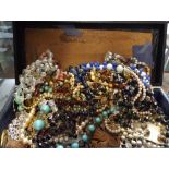 Box of assorted vintage beads, brooches,