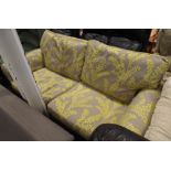 2 seater settee in fawn and yellow leaf patterned material with loose cushions