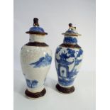 Pair of Oriental blue and white crackle glazed vases with lids decorated with pagodas,