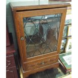 A glazed music cabinet