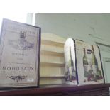 Two wine storage boxes with wine advertising designs and a small shelf