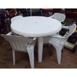 A circular plastic garden table with 4 matching chairs