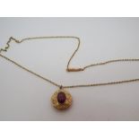 9ct yellow gold garnet set circular pendant with locket glazed compartment to reverse on a fine