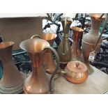 6 copper ewer shaped jugs and a copper saucepan with lid