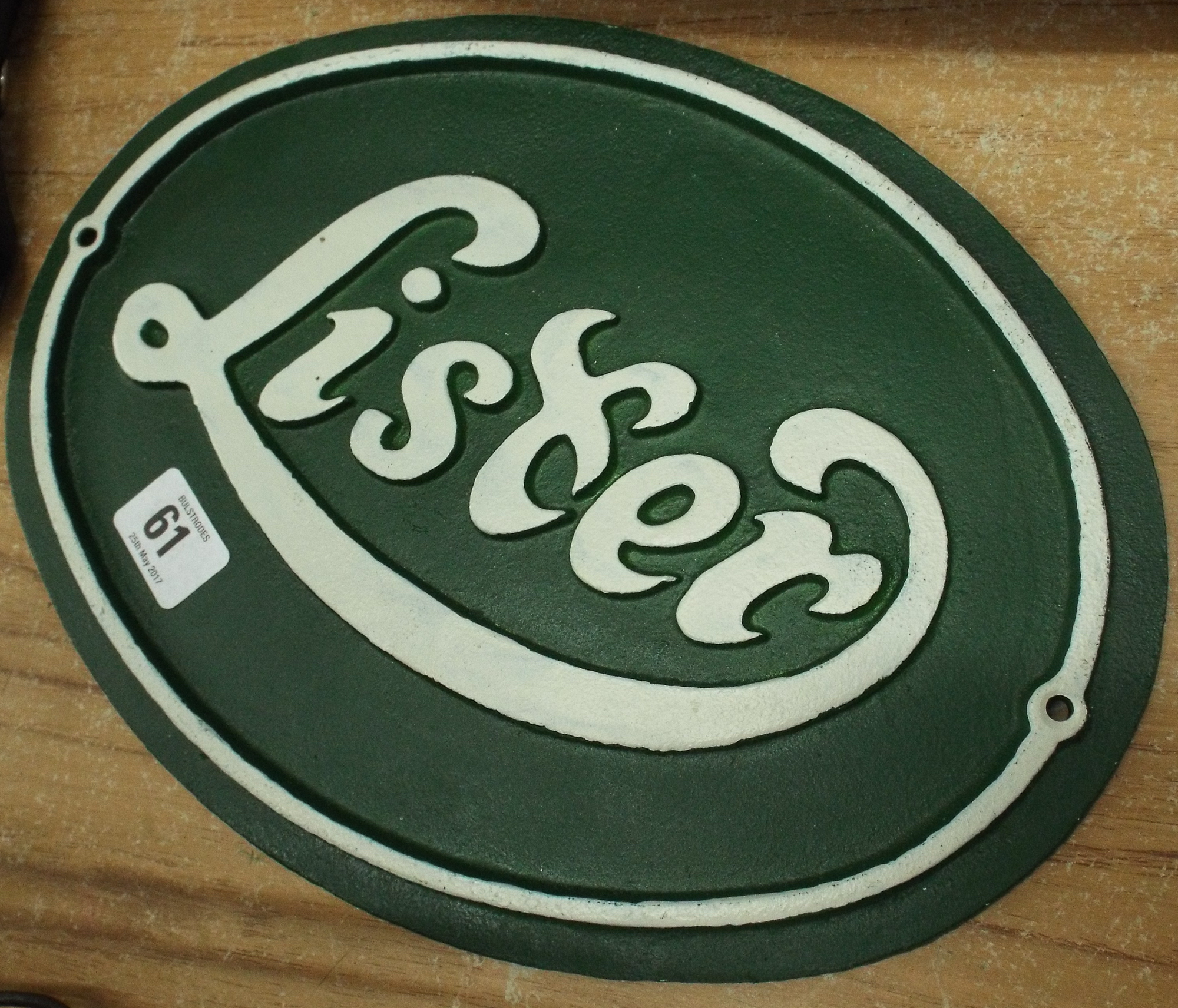 A cast iron oval advertising plaque for Lister