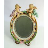 Dresden cherub mounted easel dressing table mirror with brass fitting height 28cms