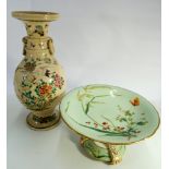 A porcelain cake comport decorated with flowers and a butterfly and a Satsuma vase.