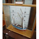 Model sailing boat in a glass display cabinet