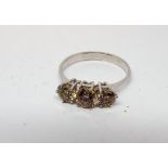 Three stone diamond ring, shank engraved '18ct',