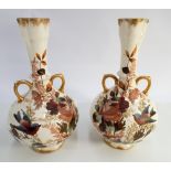 A pair of continental porcelain twin handled vases hand painted with Finches and flowers impressed