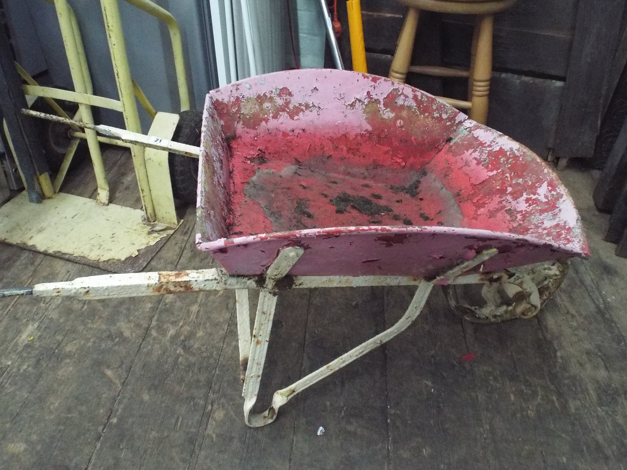 A metal wheelbarrow to use as flower bedding etc