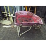 A metal wheelbarrow to use as flower bedding etc