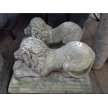 Pair of concrete garden lion ornaments,