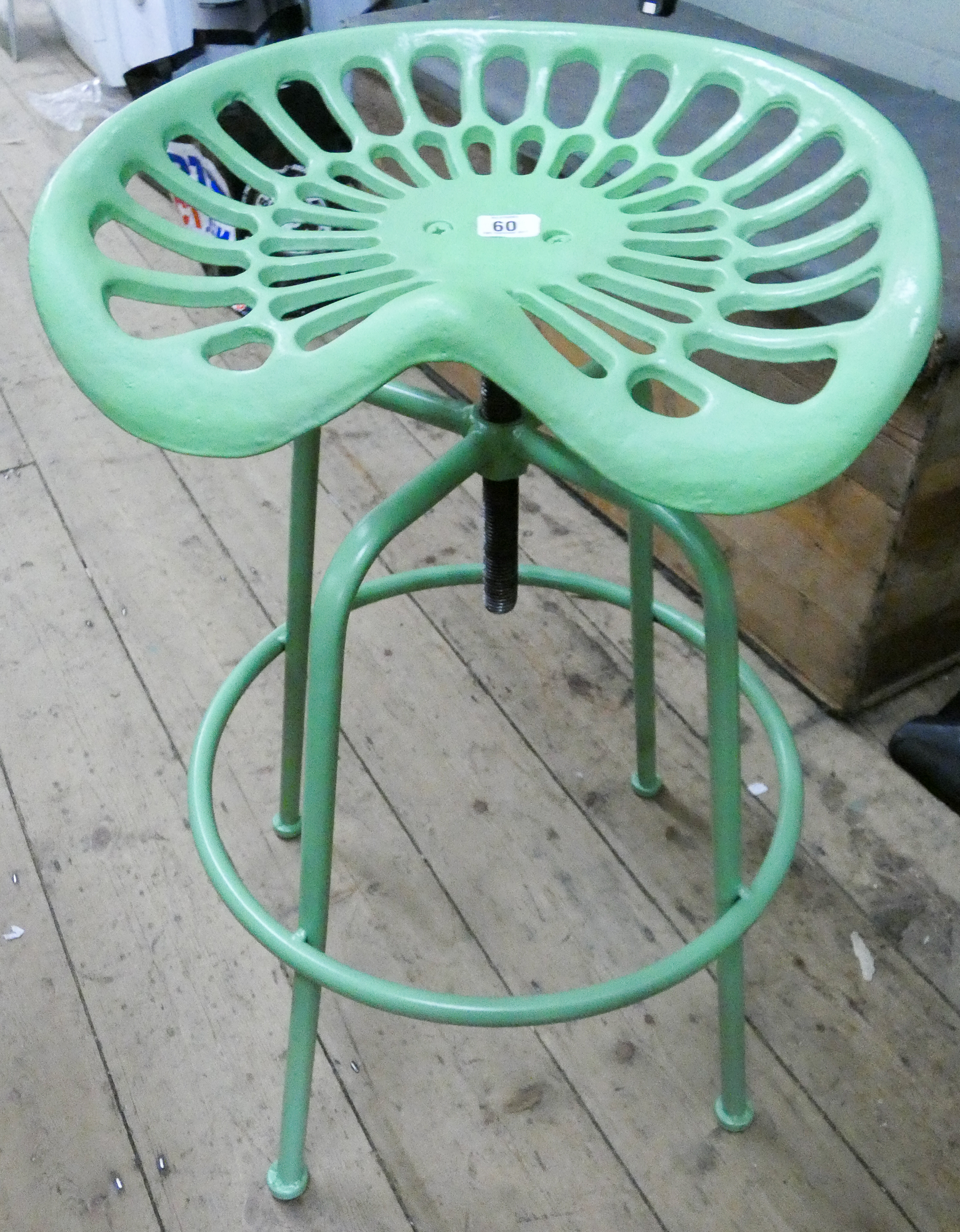 A green cast tractor seat stool