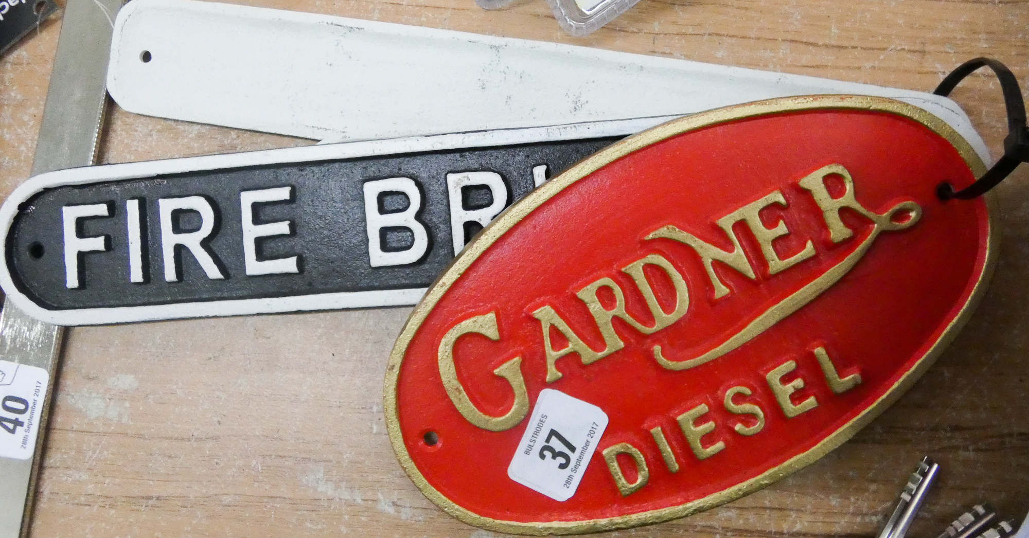 Four assorted cast iron signs Fire Brigade, SS Titanic, Gardener Diesel,