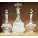 Pair of etched glass decanters and one other taller cut glass decanter