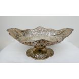 A Victorian oval silver basket on a pedestal foot embossed with flowers and foliage with