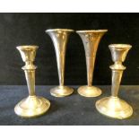 Pair of dressing table candlesticks together with two silver specimen vases, weighted bases.