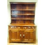 A antique oak dresser base fitted drawers and cupboards with later associated top and shelf back