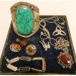 A selection of costume jewellery to include brooches, bracelet amber,