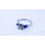 Sapphire and diamond three stone ring the central brilliant cut diamond weighing 1.