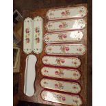 Two sets of four floral porcelain finger plates,