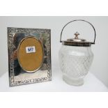 Cut glass and hallmarked silver mounted biscuit barrel and an easel photograph frame,