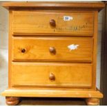 Pine three drawer bedside chest,