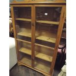 A modern pine glazed 2 door bookcase 3' wide approx 4'6 high