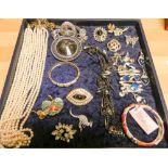 A selection of costume jewellery to include brooches,