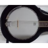 Vintage silver and black banjo guitar with six strings in its fitted hard case