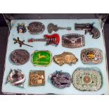 Case of 15 assorted belt buckles etc to include guitars, pistol,