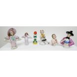 A collection of 6 Art Deco porcelain half doll pin cushion ladies to include a seated faun,