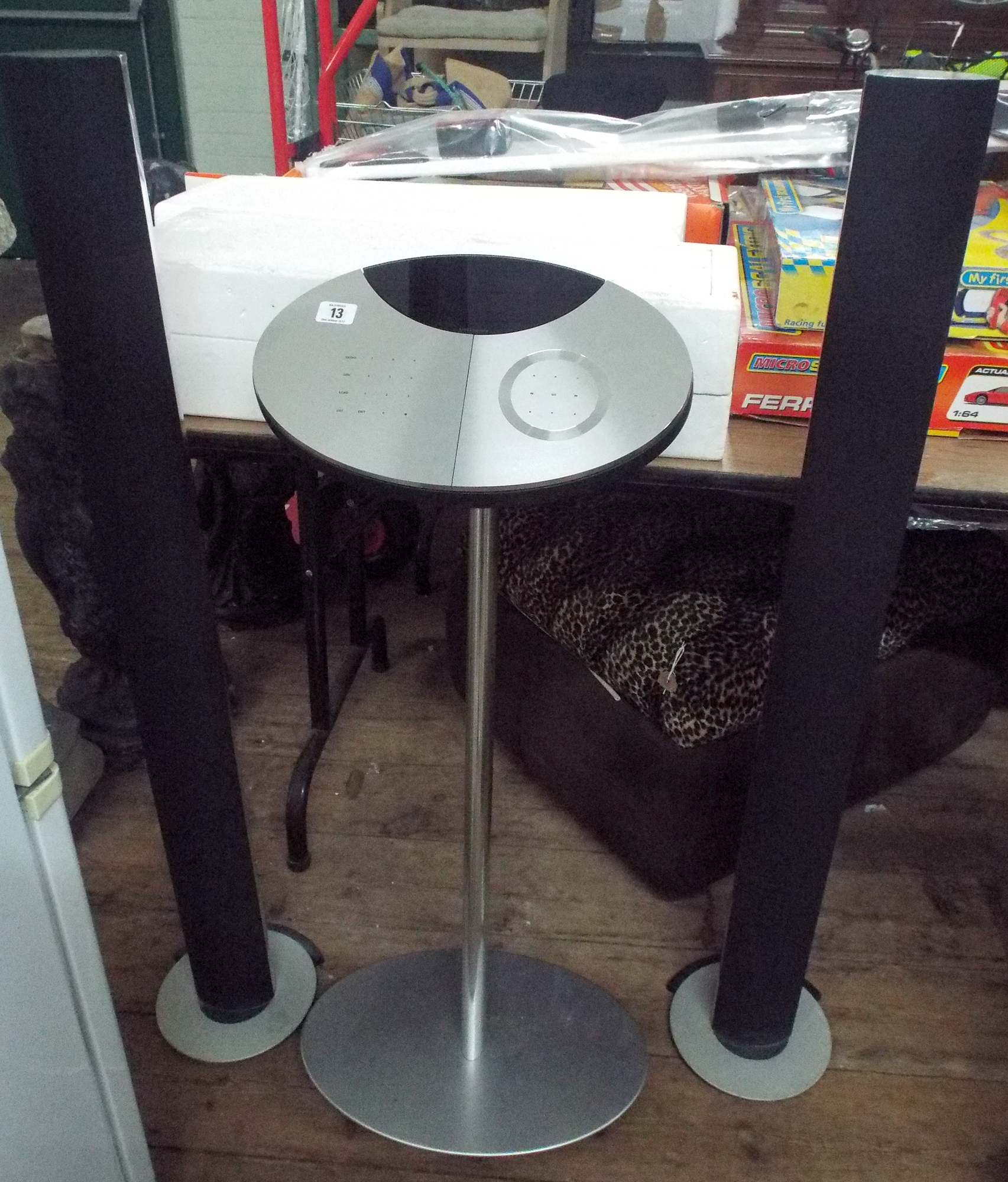 Modern Bang and Olufsen BEO Centre 2 player unit on tower base with two tall speakers,