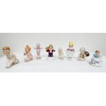 A collection of eight miniature Art Deco porcelain half dolls featuring Kewpie dolls and infants