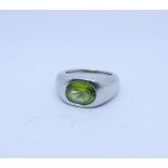 Modern handmade platinum and peridot dress ring. Platinum setting weighing 21.