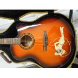 Fender six string acoustic orange and brown guitar with a cowgirl design