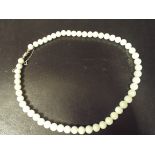 Long uniform row of pale jade beads,