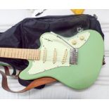 Hudson six string green electric guitar with a tremolo arm in its black fabric fitted case