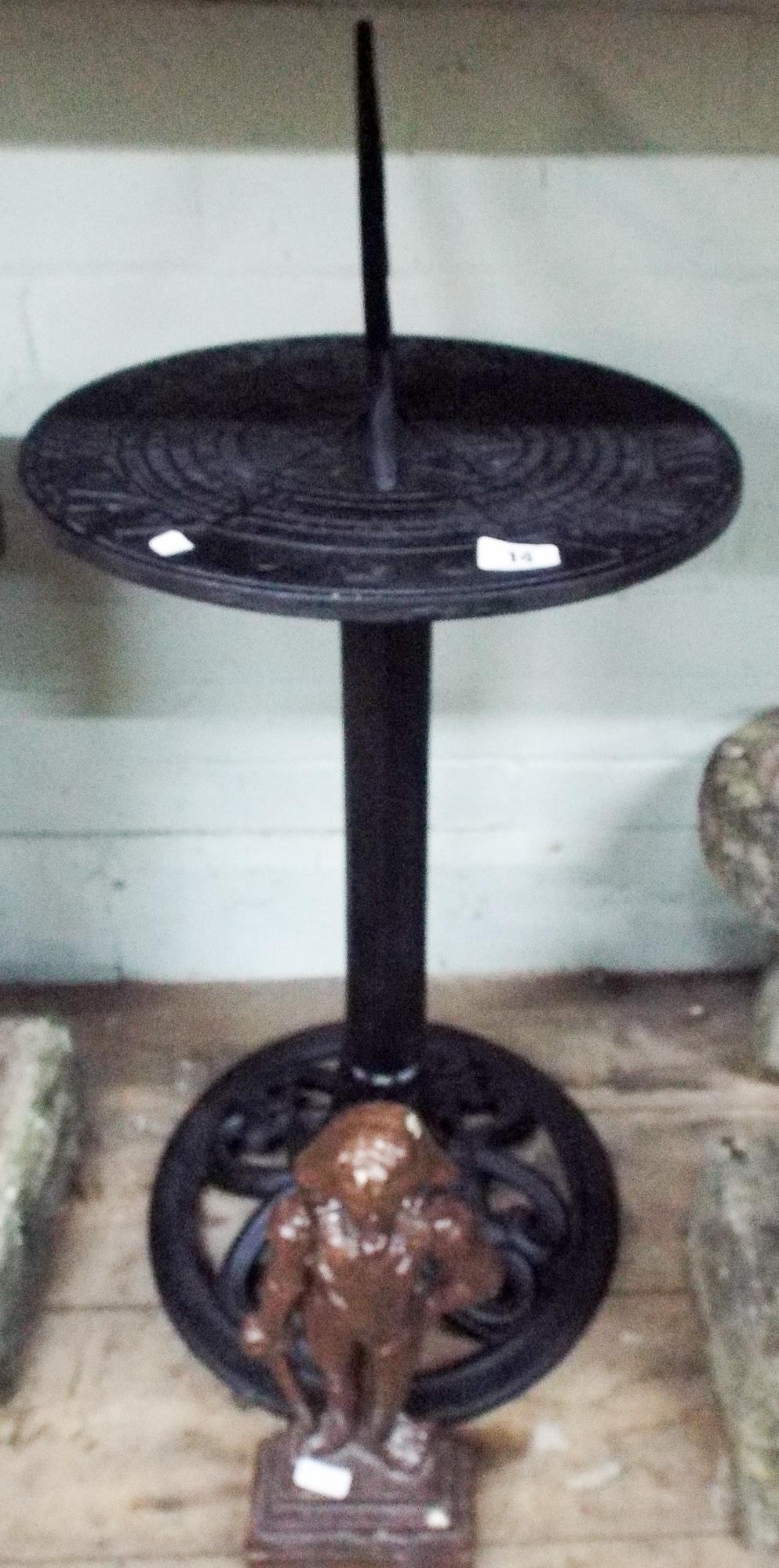 Metal black painted sundial and a Nelson heavy door stop