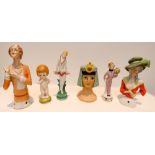 A group of six Art Deco bisque and porcelain pin cushion half dolls to include Cleopatra and Bell