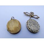 Oval locket with old enamel decoration and marked 9ct back and front on a hallmarked 9ct ribbon bow