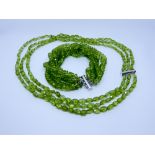 Continental 14ct white gold and peridot faceted bead three strand necklace and a similar five