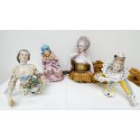 A group of four porcelain and bisque pine cushion half dolls modelled as 18th century ladies