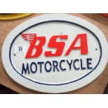 An oval painted iron BSA Motorcycle sign and a similar Royal Enfield sign