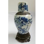 A Chinese blue and white floral and bird decorated vase on a bronze base some cracks 16"